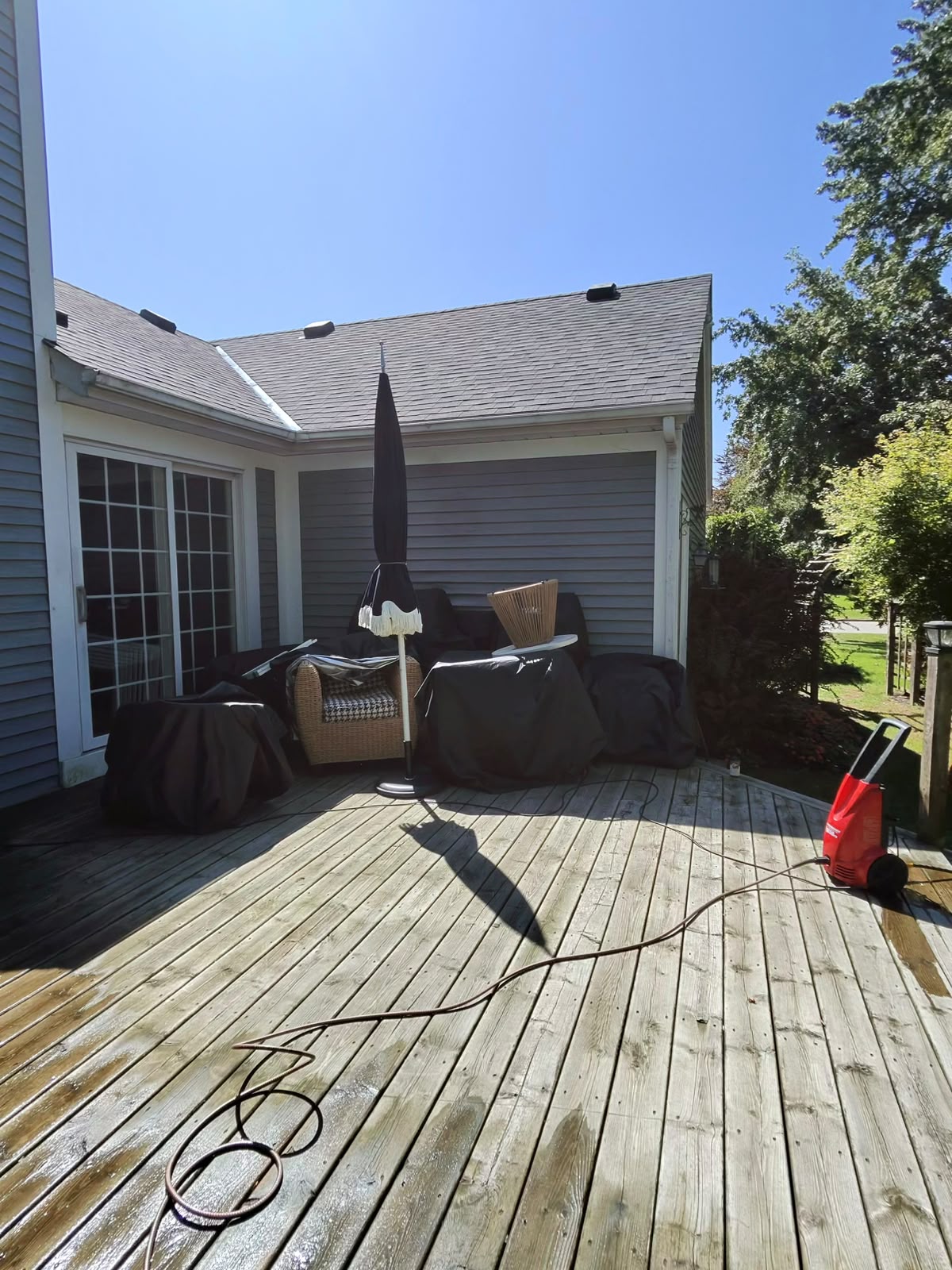 A freshly cleaned backyard deck in bright spring sunlight