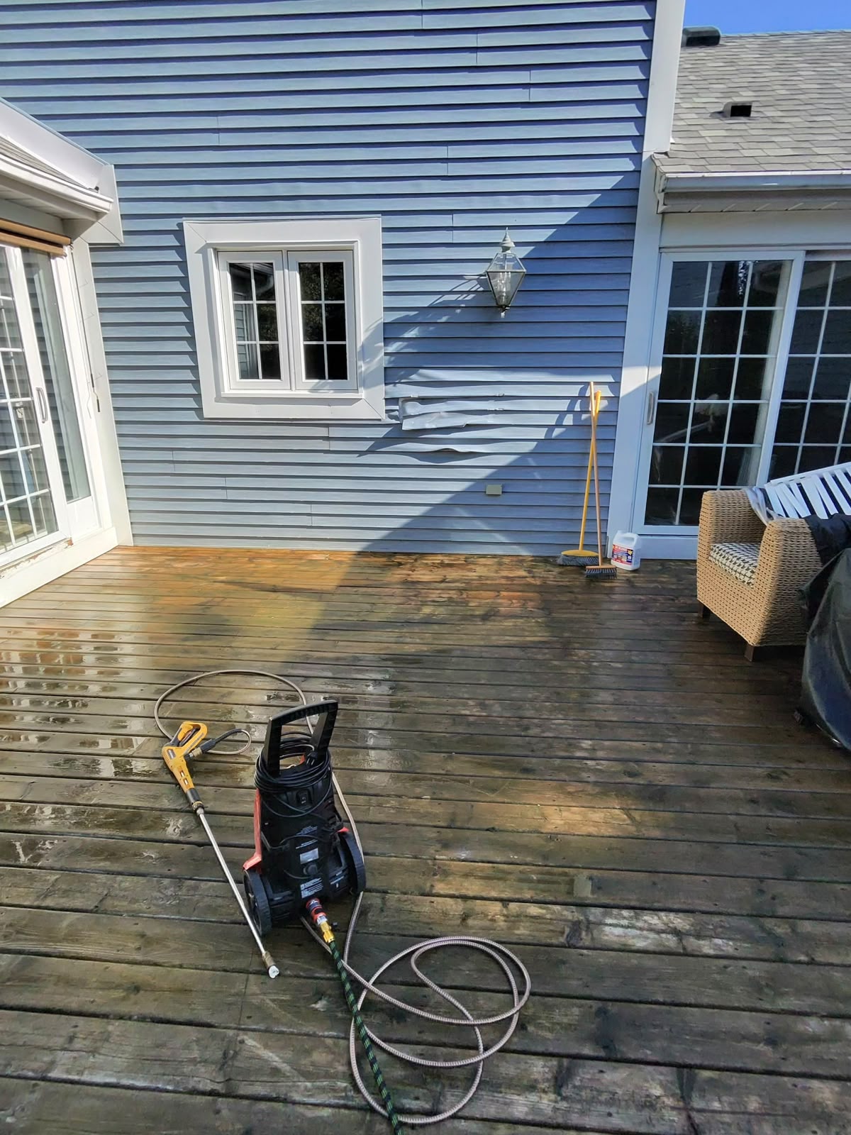 Pressure washer and cleaning tools on a deck during cleaning